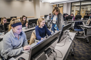 Professor teaching a class an instruction lab